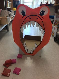 a cardboard box shaped like a monster with its mouth open