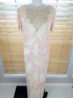 "This is an absolutely gorgeous gown. It's very intricately embellished with pink pearl beading and iridescent pink sequins. It's in good vintage condition. Size SMALL Measurements: Bust - 34/36\" Waist - 34/36\" Hips - 34/36\" Length - 57\" Size - Small Size LARGE Measurements: Bust - 42/44\" Waist - 42/44\" Hips - 42/44\" Length - 59\" Size - Large This dress comes from a pet-free and smoke-free home. If you would like more info or have any questions, please don't hesitate to ask!" Pink Evening Dresses With Pearl Embroidery, Glamorous Pink Pearl Embroidered Dress, Formal Pink Dress With Pearl Embroidery, Pink Embellished Silk Evening Dress, Formal Pink Sequined Mother Of The Bride Dress, Elegant Pink Sequined Mother Of The Bride Dress, Elegant Pink Mother Of The Bride Dress With Sequins, Pink Sequined Floor-length Gown, Silk Prom Gown With Sequins