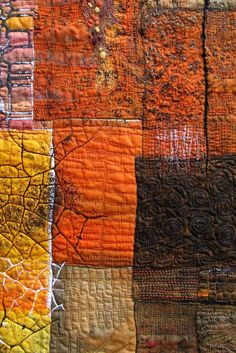 an orange and yellow patchwork quilt is shown