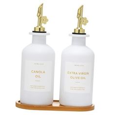 two bottles of extra virgin olive oil on a wooden tray