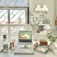 a laptop computer sitting on top of a white desk