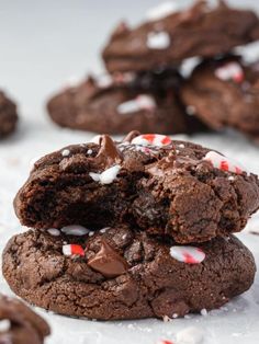 chocolate cookies with candy canes and marshmallows are stacked on top of each other