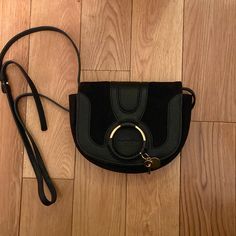 See By Chloe Mini Hana Crossbody Bag In Black. Excellent Condition. Dust Bag Included Evening Saddle Bag With Branded Hardware In Black, Evening Black Saddle Bag With Branded Hardware, Black Saddle Bag With Branded Hardware For Evening, Evening Black Saddle Bag With Palladium Hardware, Chic Black Saddle Bag With Branded Hardware, Luxury Black Saddle Bag With Silver-tone Hardware, Chic Black Saddle Bag With Metal Hardware, Chloe Bags, Chloe Handbags