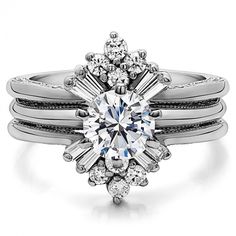 a white gold engagement ring with an oval cut diamond surrounded by round and baguettes