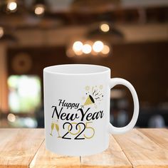 a happy new year mug sitting on top of a wooden table