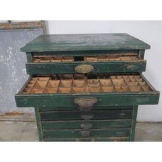 an old green dresser with many drawers