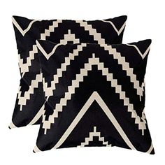 two black and white pillows sitting next to each other