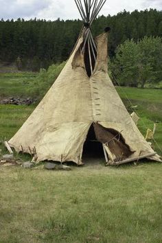 an old teepee tent in the middle of a field