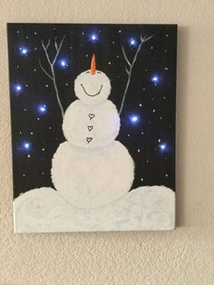 a painting of a snowman is hanging on the wall