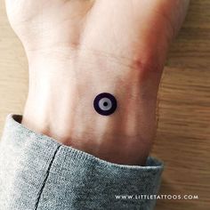 a person with a small tattoo on their wrist