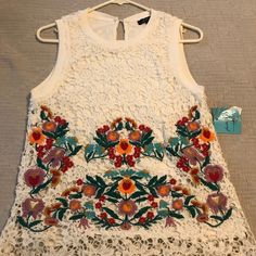 Faith + Zoe Zatacin Lace Top. Slightly Off White, Fully Lined Lace Top With Colorful Floral Detail. Excellent Condition Including Tags. Size Medium. Spring Embellished Lace Tops, Sleeveless Embroidered Top For Spring With Intricate Embroidery, Sleeveless Embroidered Top For Spring, Multicolor Lace Tops For Spring, Sleeveless Spring Embroidered Top With Floral Embroidery, Sleeveless Embroidered Floral Top For Spring, Sleeveless Floral Embroidered Top For Summer, Sleeveless Embroidered Top With Floral Design For Spring, Summer Embellished Lace Top