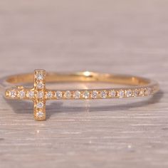 This Stunning Piece, Known As The Side Cross, Features A Captivating Sideways Cross Set With Diamonds That Continue Down One Side Of The Shank. The Ring Is Crafted In 14 Karat Yellow Gold And Is Currently A Finger Size 6.75 Yet Can Be Adjusted To Any Finger Size For An Additional Charge Upon Request, Ensuring A Perfect Fit. Yellow Gold Color, Diamond Cross, Cross Ring, The Ring, Womens Jewelry Rings, Yellow White, Gold Color, Perfect Fit, Diamonds