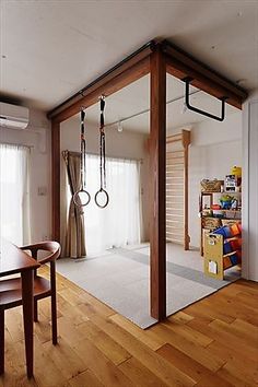 an empty room with wooden floors and large mirrors on the wall, hanging from hooks