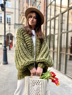 a woman holding a basket with flowers in it