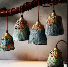 five decorative hanging lights with different designs on them