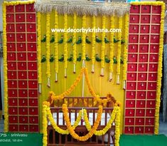 a wooden bench sitting in front of a yellow and red wall with flowers on it