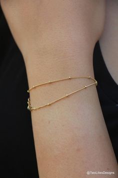 This contains an image of: {{ pinTitle }} Dainty Yellow Gold Chain Bracelet For Layering, Minimalist Hypoallergenic 14k Gold-filled Bracelets, Minimalist Hypoallergenic 14k Gold Filled Bracelets, 14k Gold Filled Satellite Chain Bracelet As Gift, Delicate Gold Bracelet With Satellite Chain, Minimalist Yellow Gold Chain Bracelet For Layering, Dainty 14k Gold Filled Adjustable Chain Bracelet, Dainty Tarnish-resistant Bracelets For Layering, Delicate Rose Gold Satellite Chain Bracelet