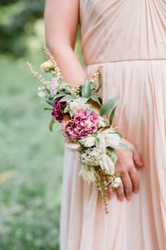 a woman in a dress holding a bouquet of flowers