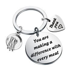 two key chains with words on them that say, you are making a difference with every meal