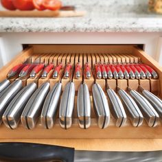 knives are lined up on a cutting board