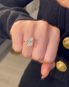 a woman's hand with a diamond ring on it