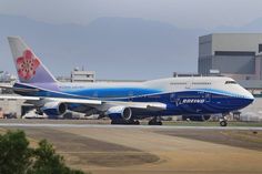 a blue and white airplane is on the runway