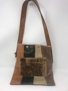 "Purchased in California at a swap meet, repurposed handmade bag used one time! strap is 1 1/4\"wide/strap drop 11\"/height 12\"/Length 11\"/smoke free environment/top closure two snaps(45)" Rectangular Patchwork Shoulder Bag For Festivals, Vintage Brown Shoulder Bag With Cell Phone Pocket, Handmade Retro Brown Shoulder Bag, Retro Brown Handmade Shoulder Bag, Brown Rectangular Shoulder Bag For Festivals, Retro Patchwork Shoulder Bag For Everyday Use, Vintage Patchwork Shoulder Bag For Travel, Retro Style Patchwork Shoulder Bag For Everyday Use, Brown Upcycled Shoulder Bag For Daily Use