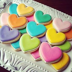 there are many heart shaped cookies on the plate