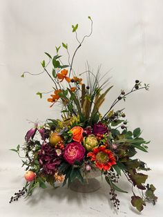 a vase filled with lots of different types of flowers