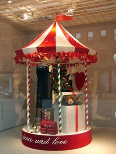 a merry christmas display in the window of a store with candy canes and love written on it