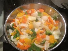 the vegetables are being cooked in the pan on the stove top, ready to be eaten