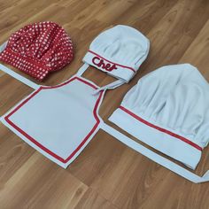 two hats and aprons are laid out on the floor