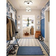 a hallway with blue and white wallpaper and rugs on the floor next to an open door