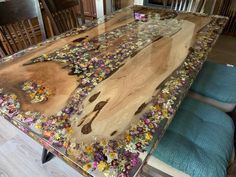 the table is made out of wood and has flowers on it