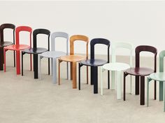 a row of different colored chairs sitting next to each other