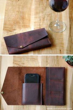 the leather wallet is next to a glass of wine