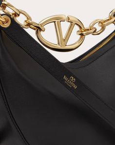 Valentino Garavani VLogo Moon Mini Hobo Bag in nappa leather featuring chain with metallic VLogo Signature element. The bag can be worn as a crossbody bag or handbag thanks to the chain and removable leather shoulder strap. - Gold-finish chain and hardware - Removable leather shoulder strap - Zip closure - Nappa leather lining. Interior: one slip pocket - Shoulder strap drop length: 58 cm / 22.8 in. - Chain drop length: 12.5 cm / 4.9 in. - Dimensions: W20xH23xD8 cm / W7.9xH9.1xD3.1 in. - Made in Luxury Gold Hobo Bag, Luxury Hobo Bag With Gold-tone Hardware For Evening, Luxury Evening Hobo Bag With Gold-tone Hardware, Designer Gold Hobo Bag For Evenings, Designer Gold Hobo Bag For Evening, Chic Shoulder Bag With Metal Logo For Everyday Luxury, Elegant Hobo Bag With Chain Strap, Luxury Evening Hobo Bag With Branded Hardware, Luxury Hobo Bag With Branded Hardware For Evening