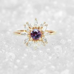 "Cluster round purple sapphire & diamonds engagement ring - Odyssey. Vintage and art deco style. Sapphire is September's birthstone. Listing is of the engagement ring alone. Ring details: ♥ Center stone: Beautiful natural round purple sapphire about 0.5ct. ♥ Side stones: Natural white diamonds, marquise cuts, about 0.60ct, F color, VS clarity. ♥ Material: 14K or 18k, yellow / white /rose solid gold. ♥ Sizes available: 4 - 11. ♥ You can request an IGL Jewelry certificate when ordering. Please Purple Diamond Ring With Rose Cut For Gift, Purple Diamond Ring With Halo Setting And Round Cut, Purple Sapphire Ring With Halo Setting, Purple Sapphire Ring With Brilliant Cut, Luxury Purple Sapphire Wedding Ring, Fine Jewelry Amethyst Diamond Ring, Purple Diamond Halo Ring, Purple Tanzanite Ring With Brilliant Cut, Heirloom Purple Diamond Ring