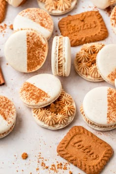 some cookies are laying on a table with frosting and cinnamon sprinkles