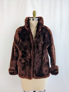 "This incredibly soft, stunning reddish brown vintage fur coat is in fantastic condition! There is a bit of damage to the cuffs of the sleeves, and near the pockets. It is also missing the top hook closure. Unfortunately due to the age of the coat, the fur is shedding.  Measurements: Bust: 44\" Waist: 44\" Hips: 44\" Shoulder to hem: 23\" Sleeve length: 23\" Cuff: 14\"" Brown Faux Fur Winter Outerwear, Vintage Brown Outerwear With Faux Fur Trim, Retro Brown Faux Fur Coat, Winter Fur Coats, Brown Luxury Long-sleeve Fur Coat, Vintage Brown Faux Fur Outerwear, Fur Coat Vintage, Reddish Brown, Vintage Fur