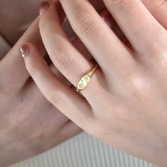 a woman's hand with a gold ring on it