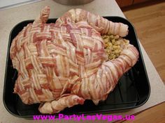 bacon wrapped chicken sitting on top of a black tray