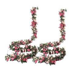 pink and white flowers are arranged in the shape of letters