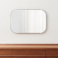 a mirror on the wall above a dresser