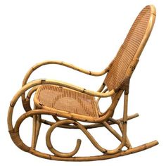 a wooden rocking chair with wicker seat and armrests on an isolated white background