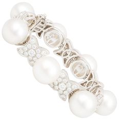 This South Sea pearl and diamond bracelet features seven large pearls separated by seven motifs in white gold. The untreated South Sea pearls measure 16mm in diameter. They display a beautiful nacre and their splendid natural color and high luster have not been enhanced in any way. The interspersed gold sections are set with a total of 8.80 carats of round diamonds of top quality (F/G-VVS, color, clarity and cut). Please note the diamonds in the bracelet's profile as shown in the picture carouse Diamond Cuff Bracelet, Pearl Cuff Bracelet, Diamond Bracelet Design, Pave Diamond Earrings, Pearl Cuff, Diamond Cluster Earrings, Golden South Sea Pearls, Tahitian Black Pearls, Pearl Bangle