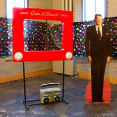 a man in a suit standing next to a display