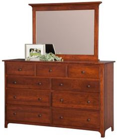 a wooden dresser with a mirror on top of it