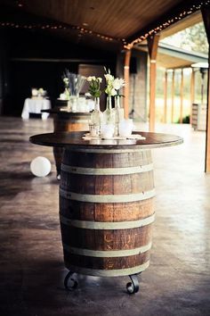 an image of a wine barrel table with flowers on it and the words, wedding share