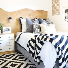 a bedroom with black and white decor on the walls